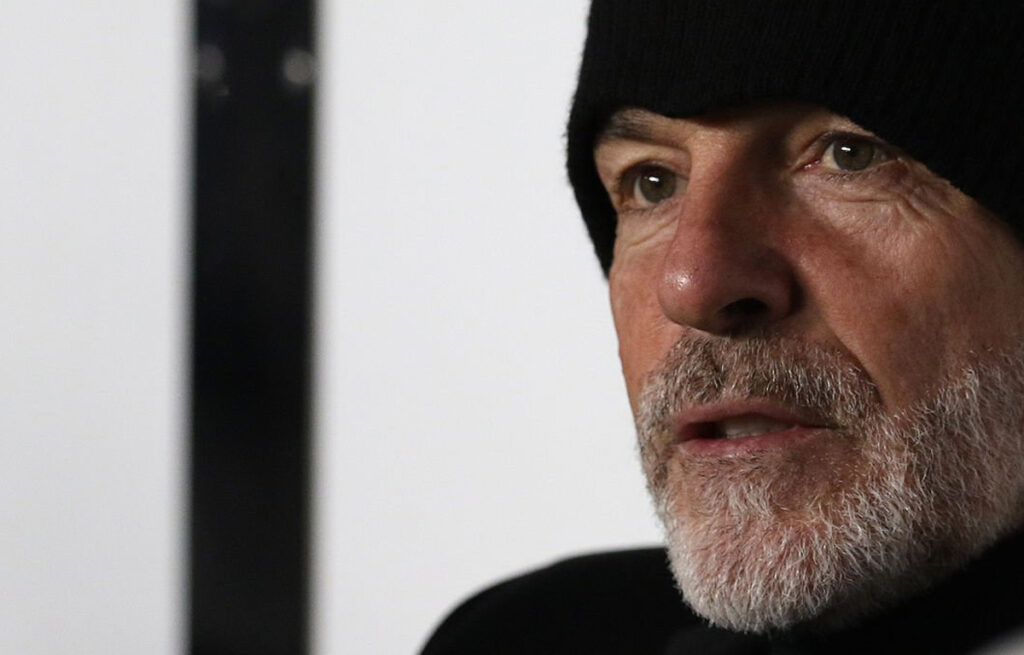 Stefano Pioli con il cappellino seduto in panchina